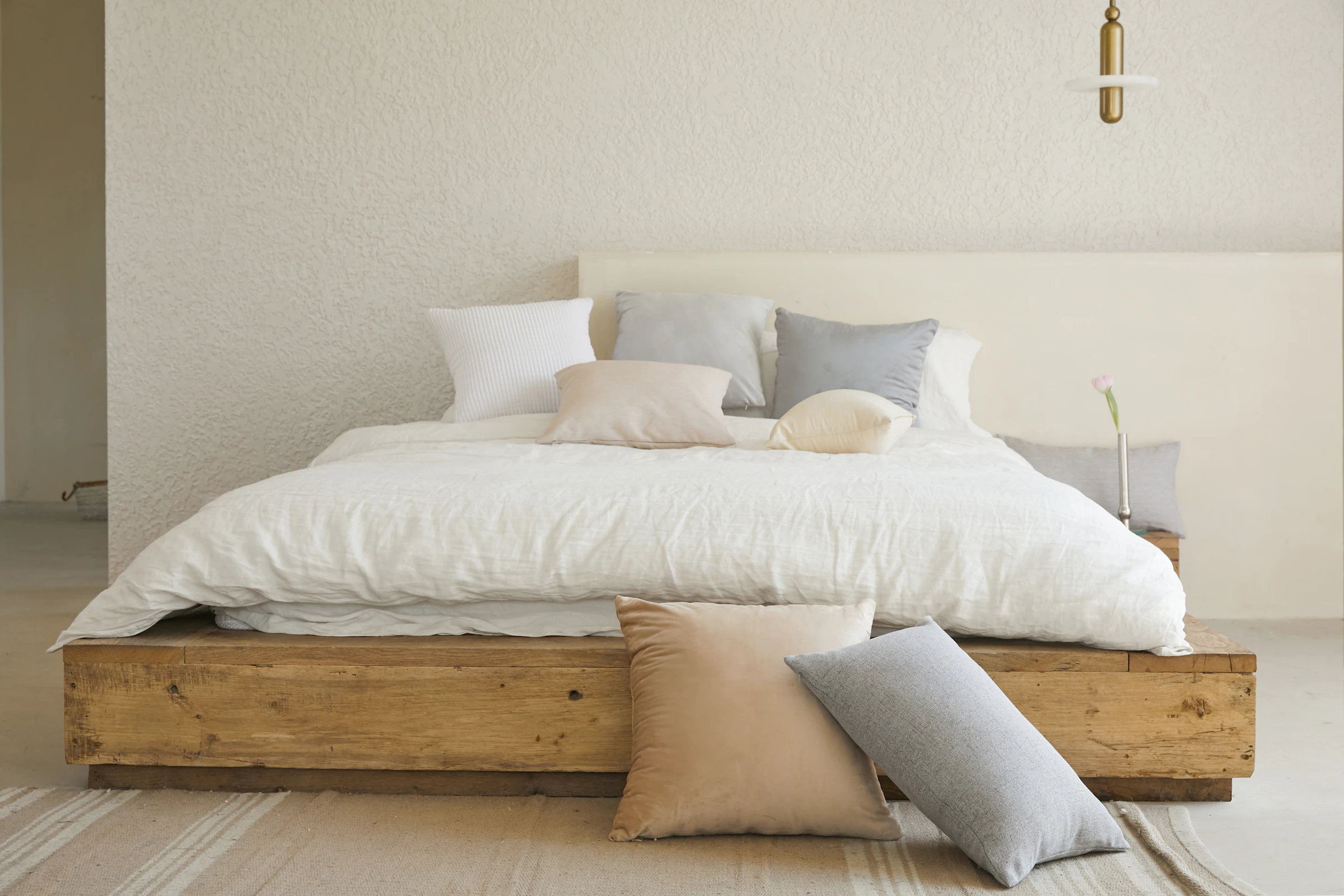 Bedroom with a reclaimed-timber platform bed and soft linens