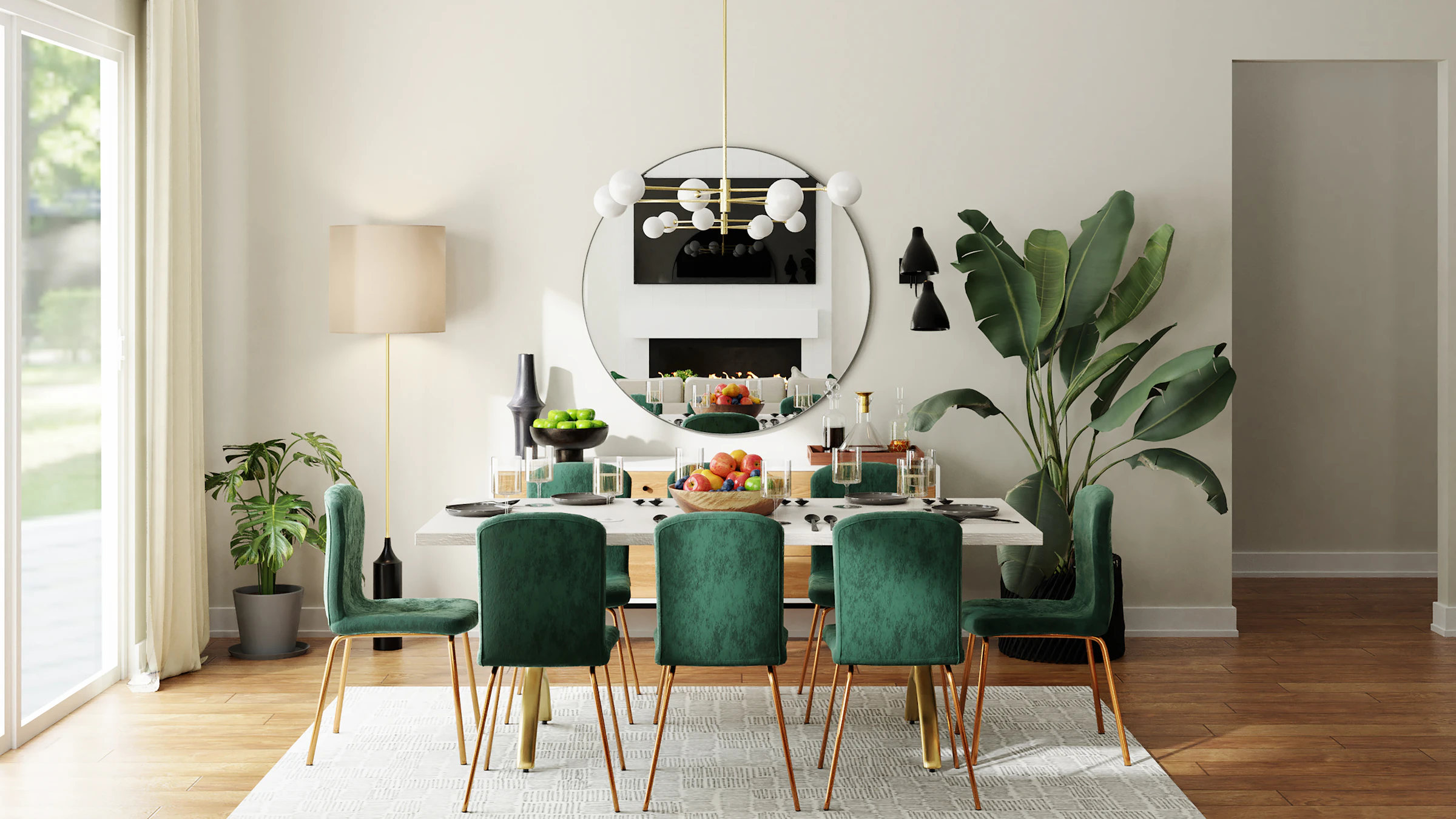 Dining area with green velvet chairs and a round mirror