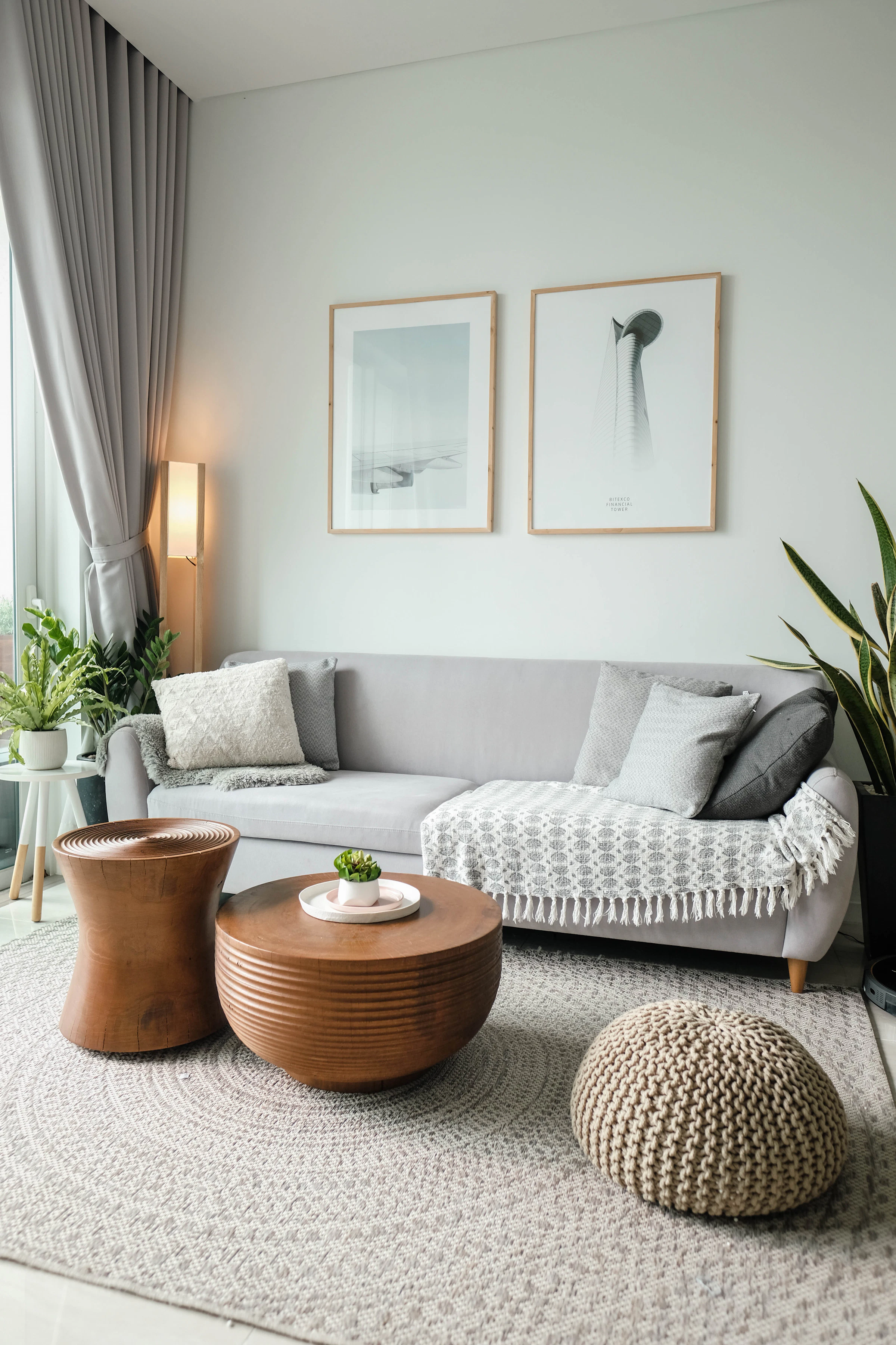 Small living room with a round timber coffee table and a knitted pouf