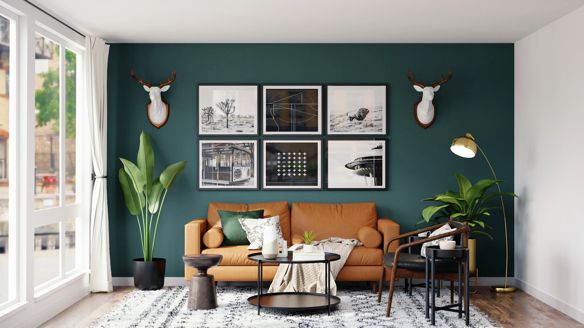 Living room with a deep teal wall, a gallery of prints and a leather sofa